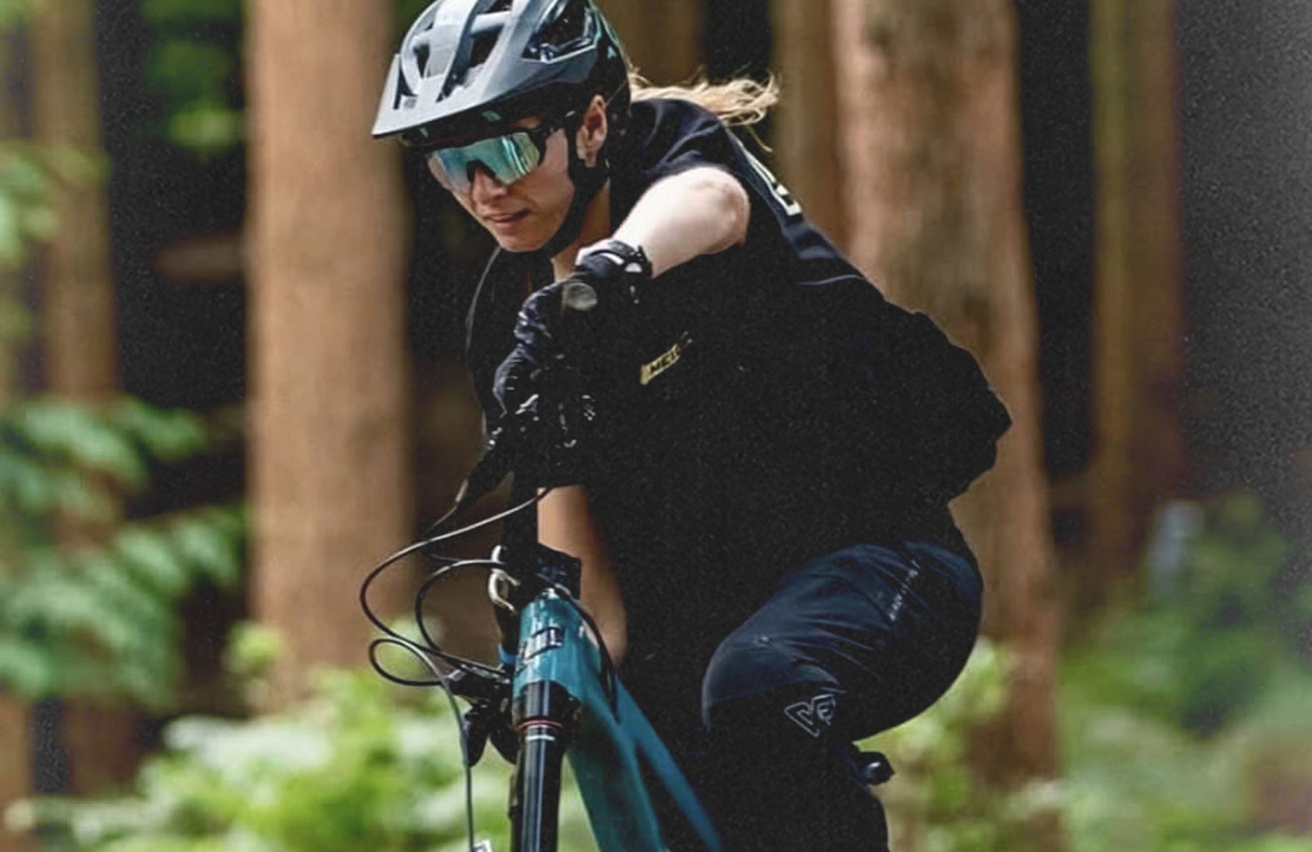 Rider wearing Winch & Plummet MTB Pro Trousers, side profile on the trail
